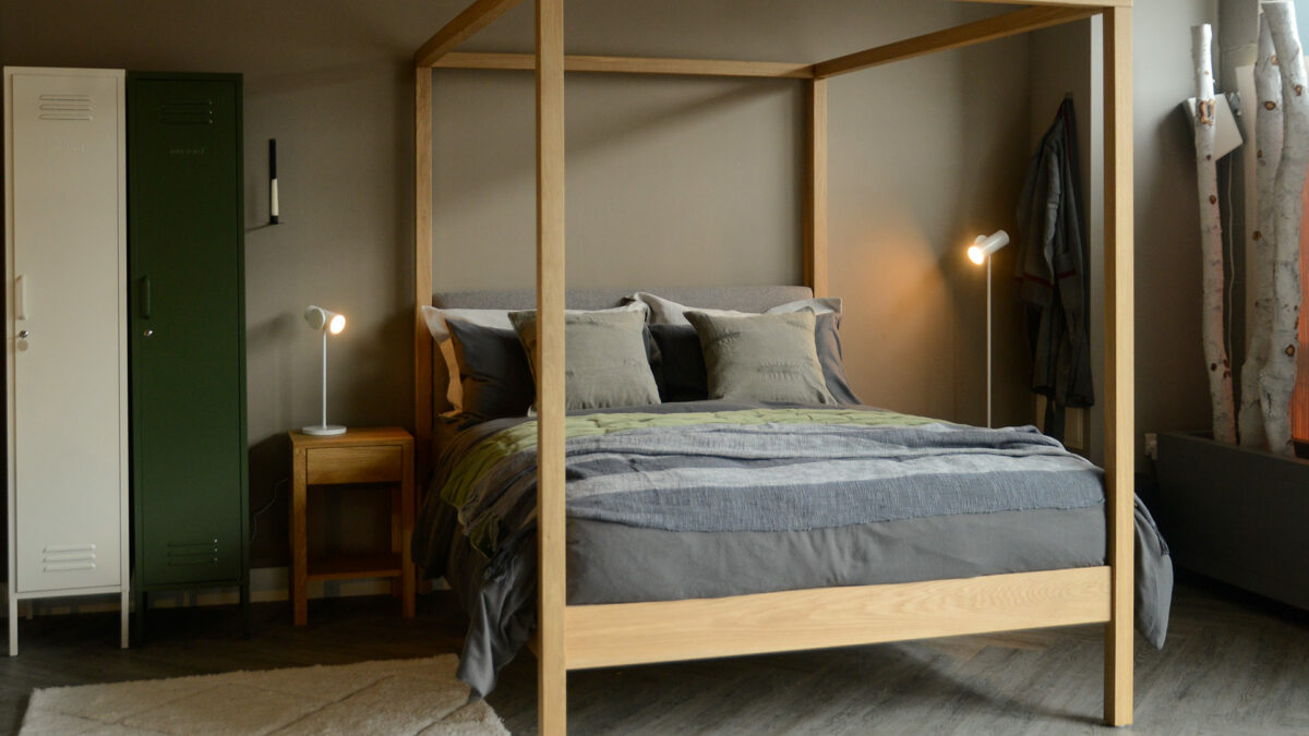 grey stripe throw with khaki cushions on 4 poster