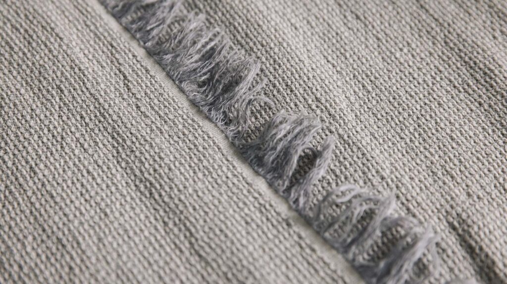 grey textured bedspread detail