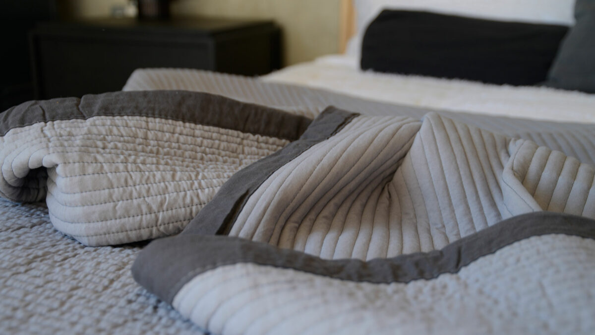 modern plain grey quilted bedspread with a dark grey border