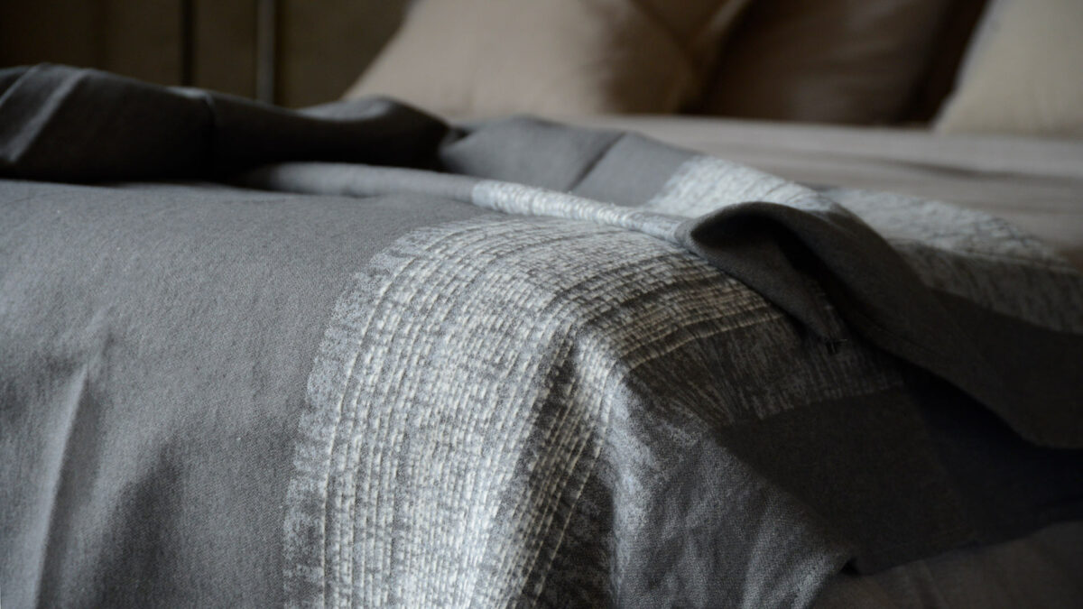 grey throw with textured stripe in ivory
