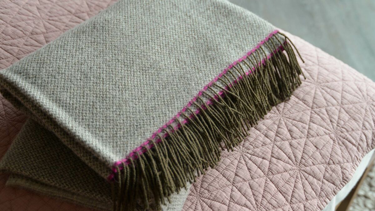grey woven pure wool throw with pink edge and brown finge
