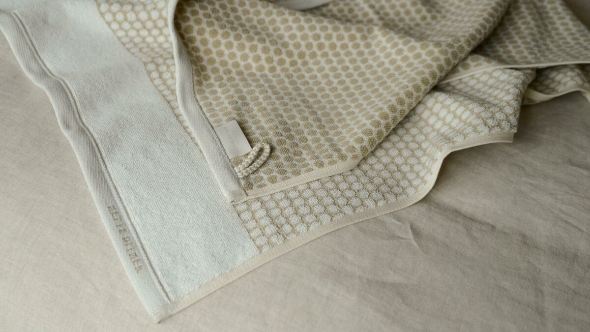 dots pattern towel in beige and white