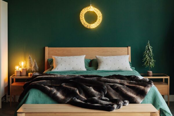 Scandi style Christmas bedroom with oak furniture and faux fur throw