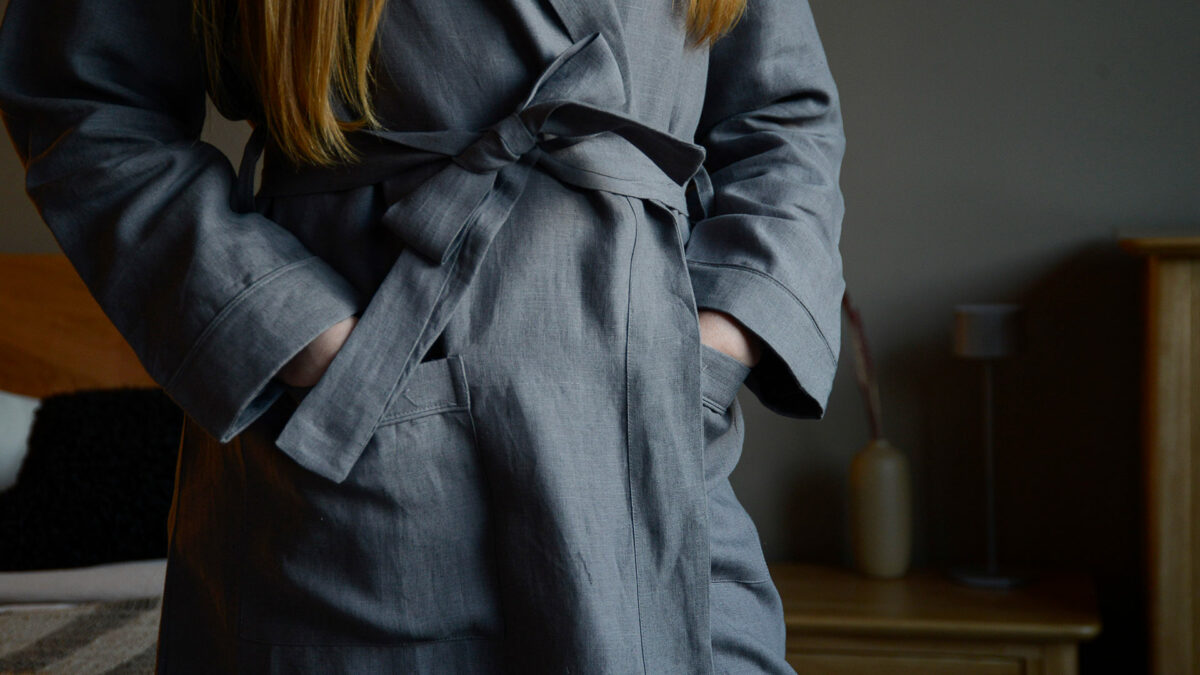 organic linen robe with pockets in charcoal grey and shown close up