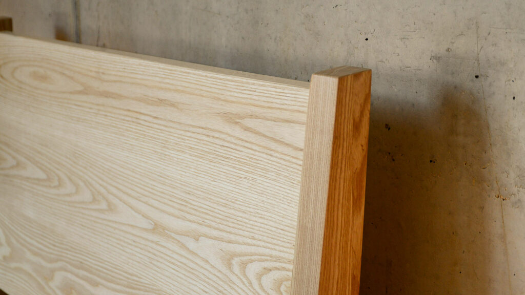 a closer look at the sloping headboard of our classic Zanskar bed frame hand crafted in solid Ash wood