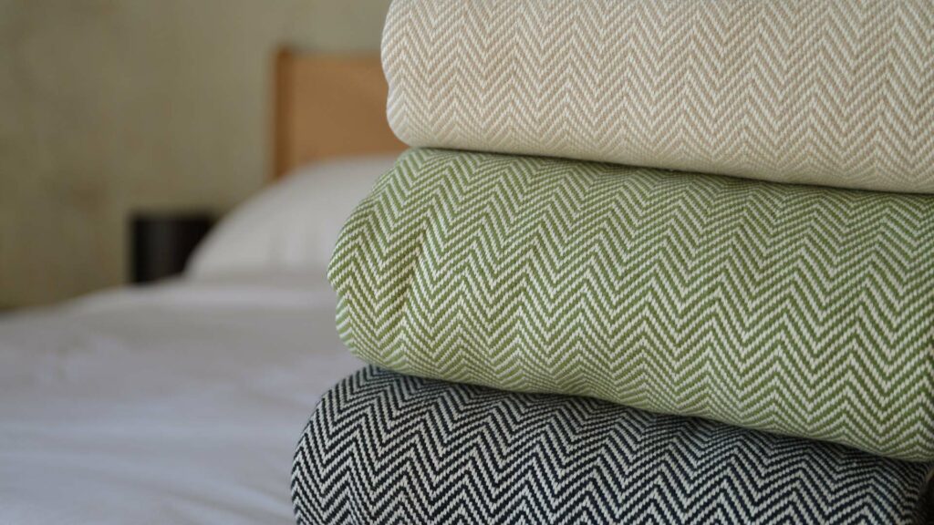 Hand woven cotton blankets with two colour herringbone weave in 3 colour choices