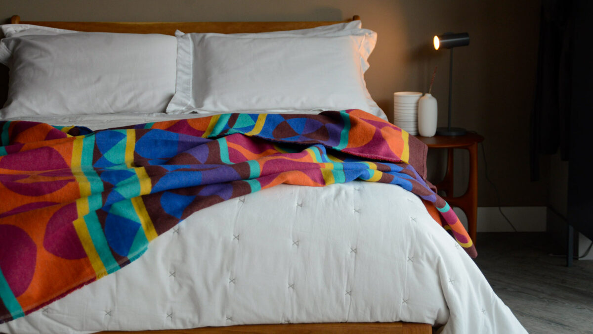 vibrant pattrened soft cotton throw in rainbow colours