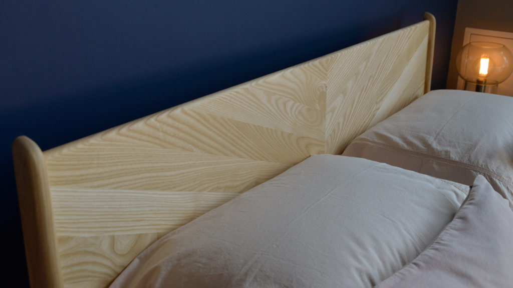 A close view of the chevron pattern Hoxton headboard hand-made from sustainably sourced solid wood.