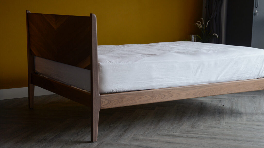 the Hoxton handcrafted solid wood bed with chevron pattern headboard shown from the back here it is made in Walnut