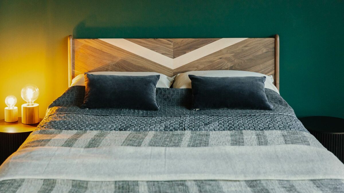 A walnut Hoxton bed headboard with contrast chevron inlay in Maple wood