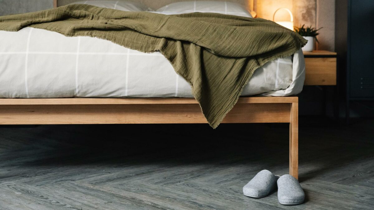 isabel felt slippers at the foot of our shetland taller wooden bed in cherry