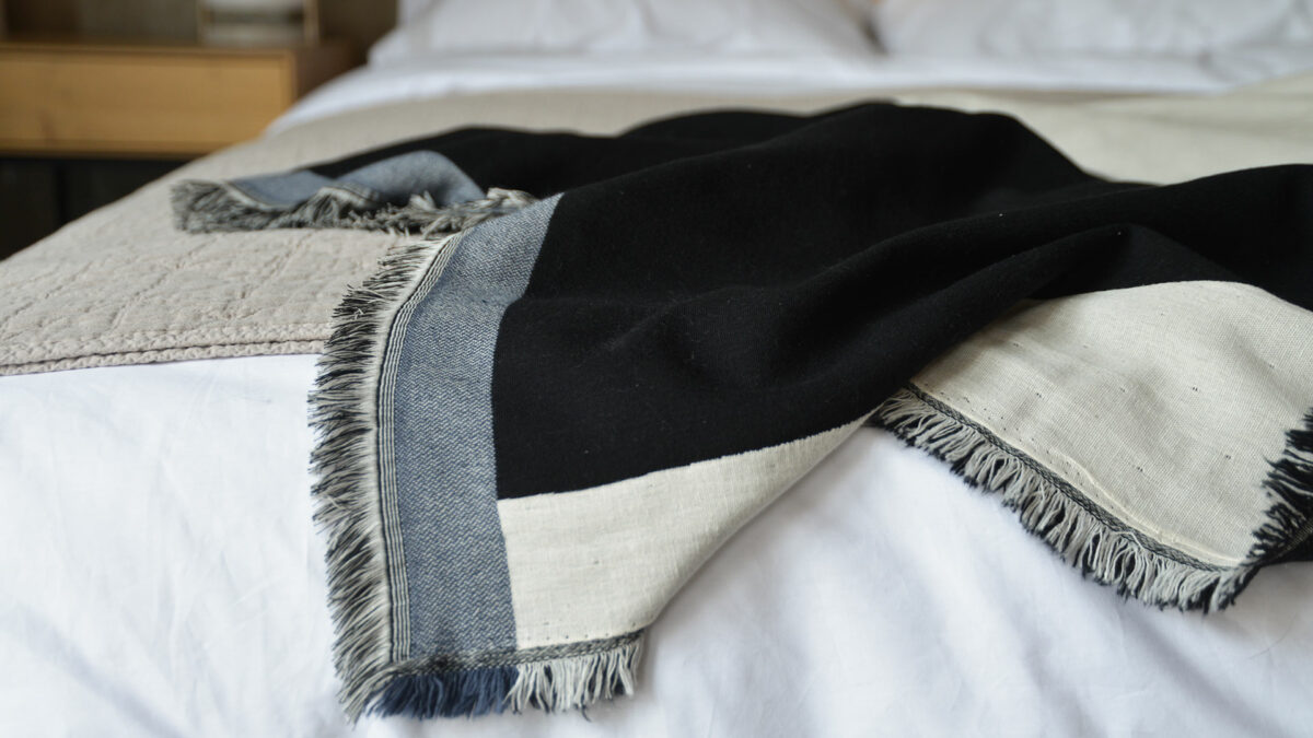 ivory and black modern throw with navy edge