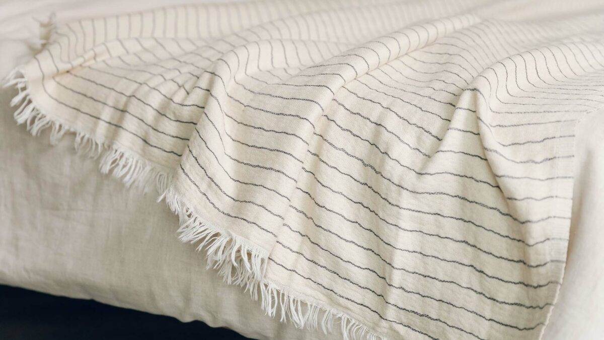 ivory cotton throw with black stripes and tassel edges