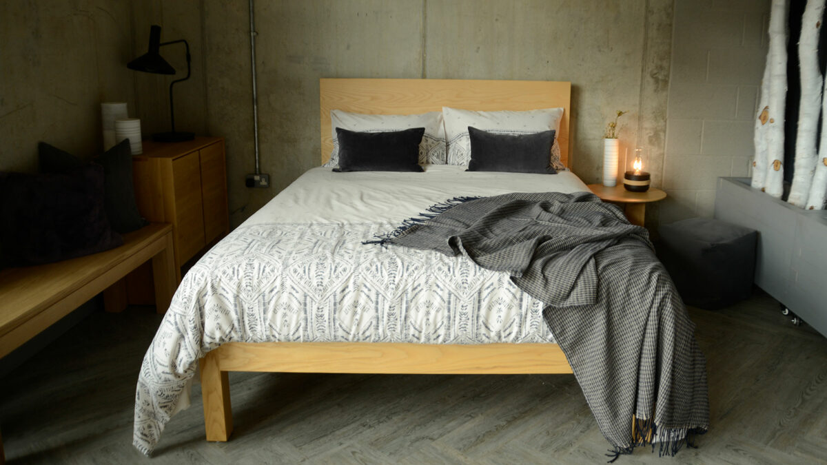 grey and ivory printed duvet cover set shown on a king size wooden bed