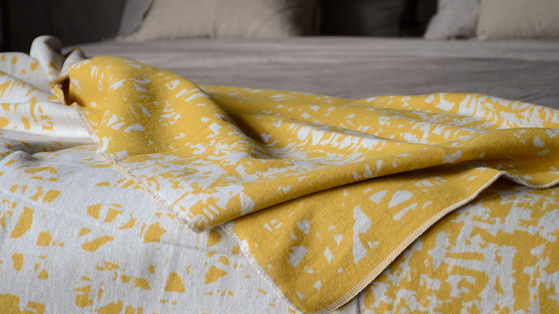 soft recycled cotton reversible throw in yellow and ivory a closer view