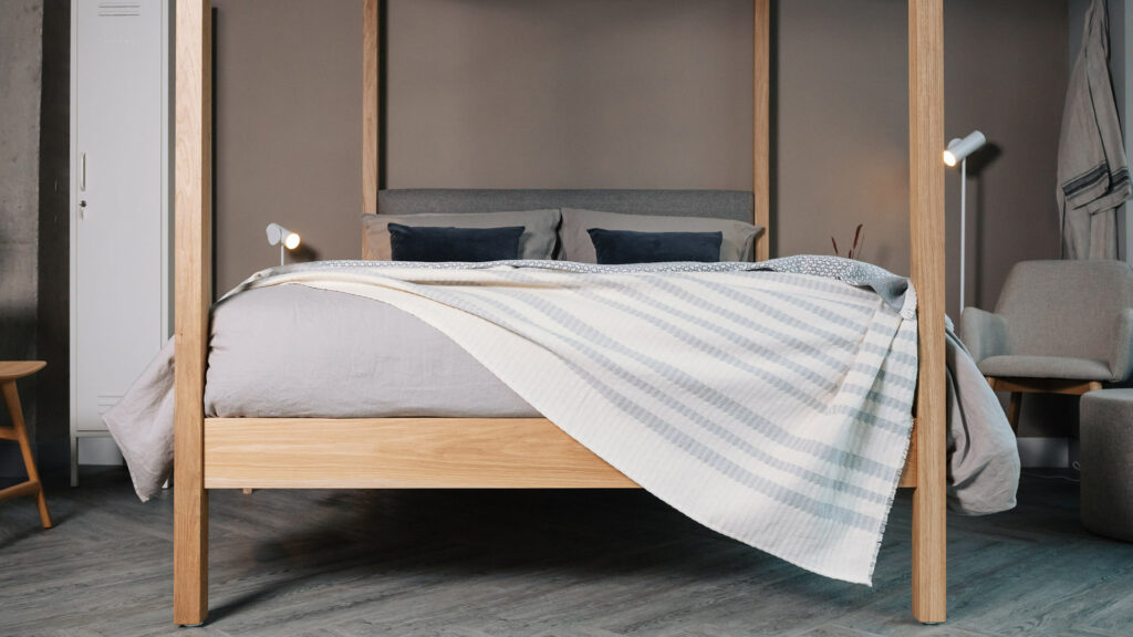 ivory and grey striped and textured cotton blanket shown draped on a kingsize bed