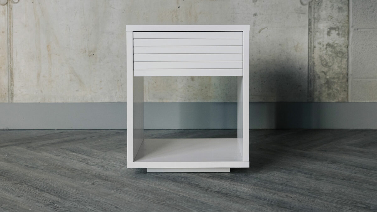 ivory finished bedside table with groove effect panel
