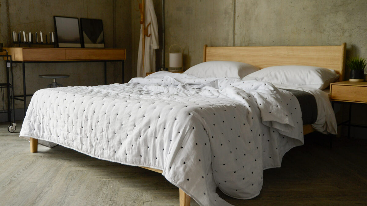 ivory quilted bedspread with almost black embroidered dots