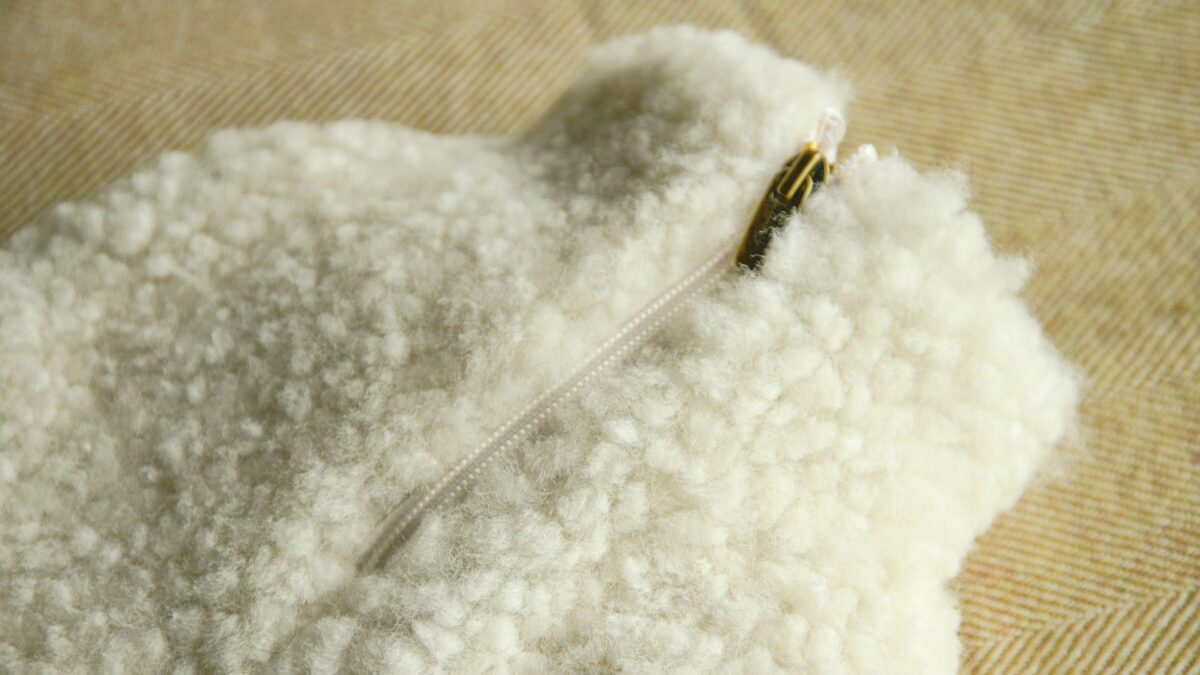 soft sheepskin covered hotwater bottle in an ivory colour