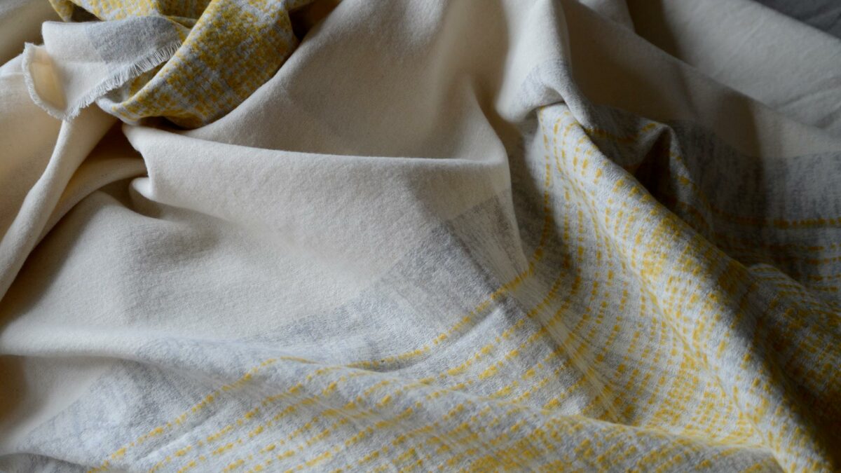 ivory throw with grey and yellow stripe edges