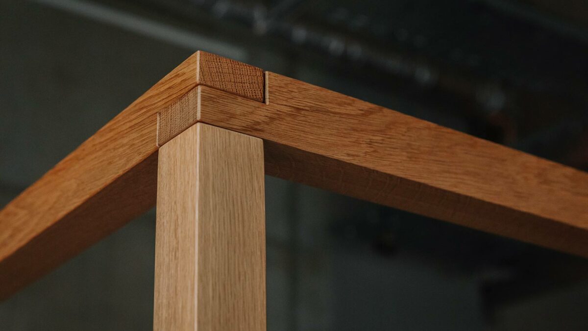 A close up view of the upper frame of the hand crafted Kelham 4 Poster bed in solid oak