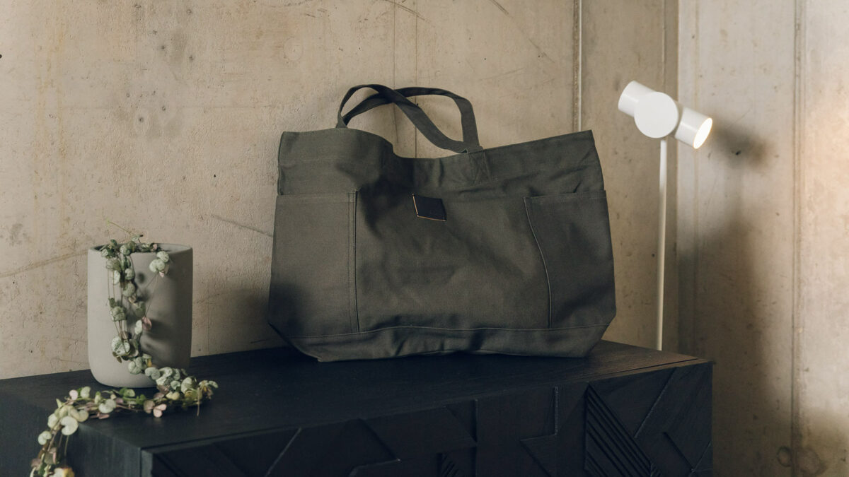 Khaki coloured canvas holdall bag with pockets