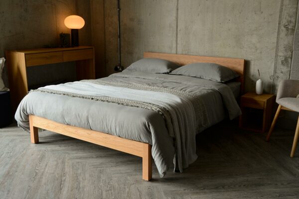 Contemporary king size cherry wood Sahara bed shown with grey bedding