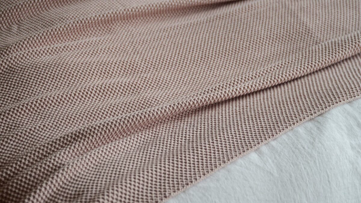 moss stitch knitted cotton throw in blush pink