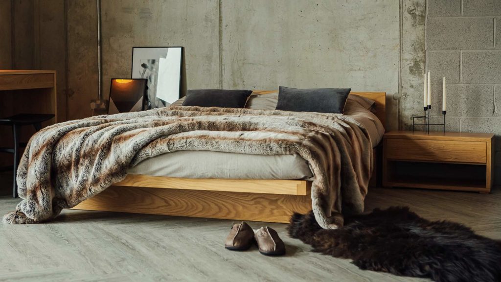 Luxurious faux-fur bedspread draped across a King size Kyoto bed in Oak