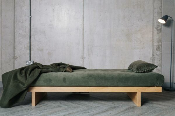solid oak kyoto day bed with sprung mattress in olive green shown side on