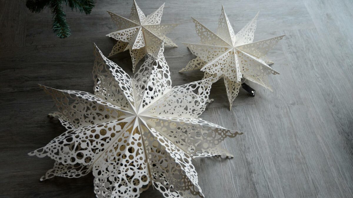 paper star Xmas decorations with cut-out lace patterns