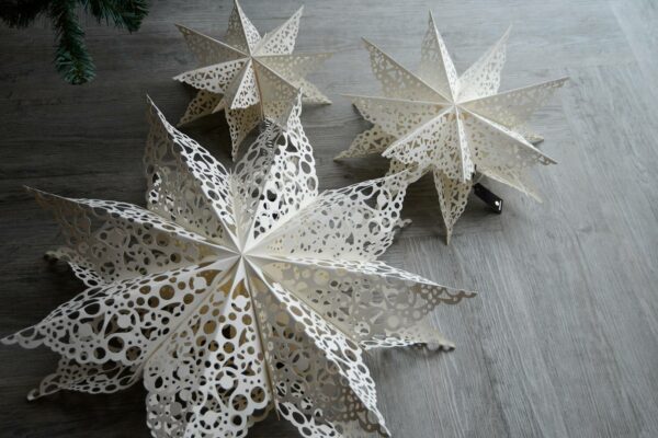 paper star Xmas decorations with cut-out lace patterns