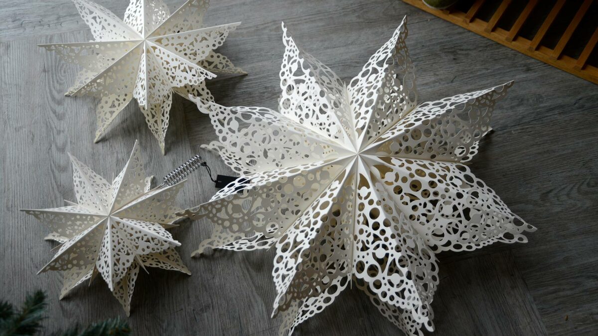 paper star Xmas decorations with cut-out lace patterns