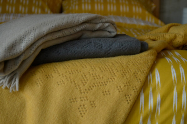 lace pattern throws on ikat stripe bedding