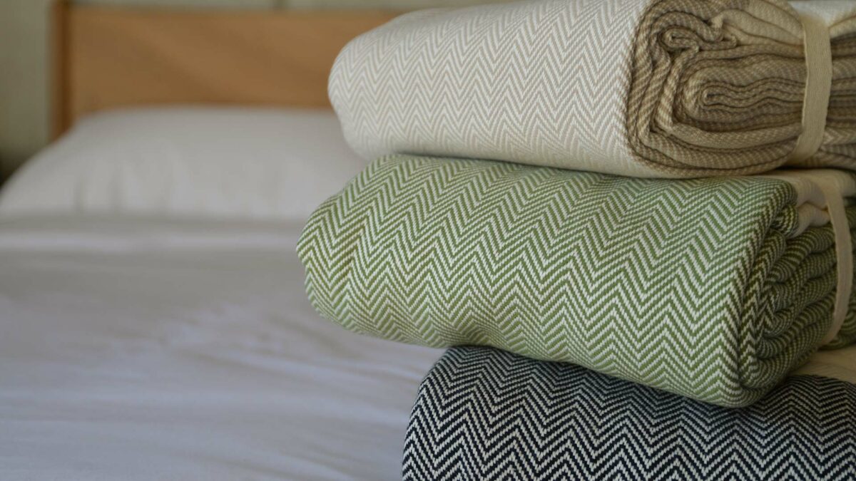 Ethically made woven cotton blankets with herringbone weave and in 3 colour options