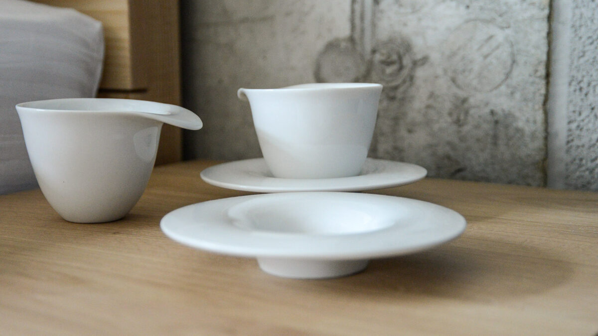 set of white porcelain coffee cups with saucers