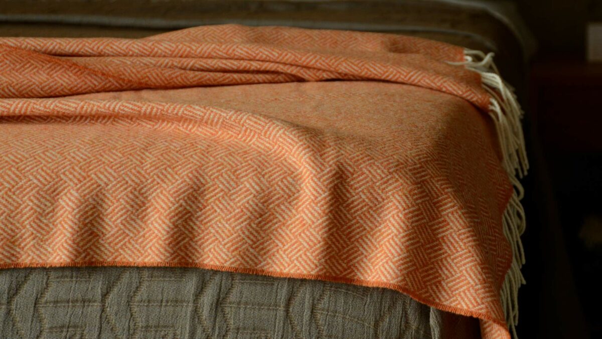 basket weave lambswool throw in orange and ivory