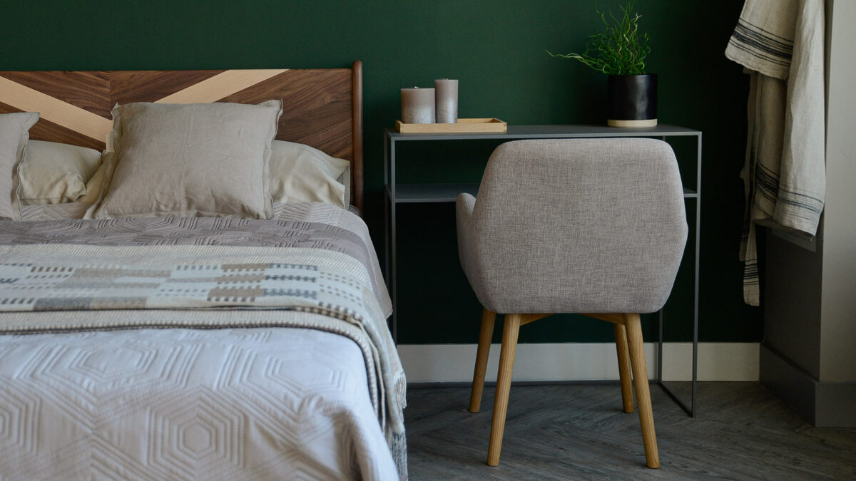 upholstered chair with wooden legs shown from the back