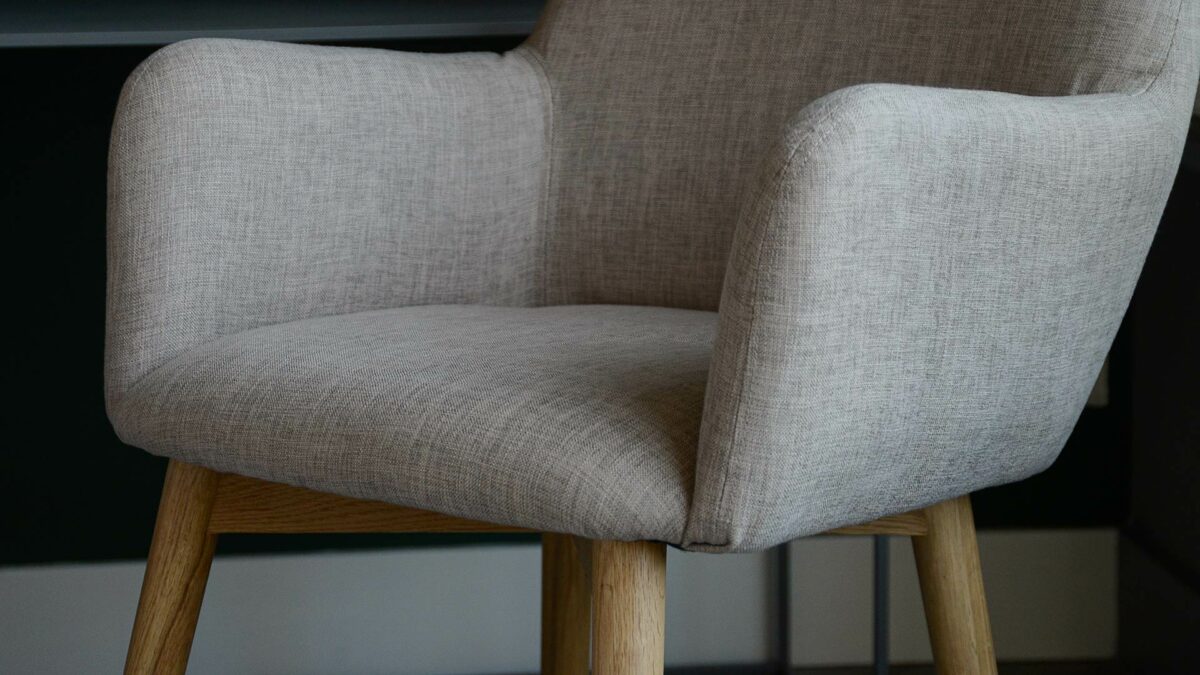 close up view of the upholstery of Lauren chair with wooden legs