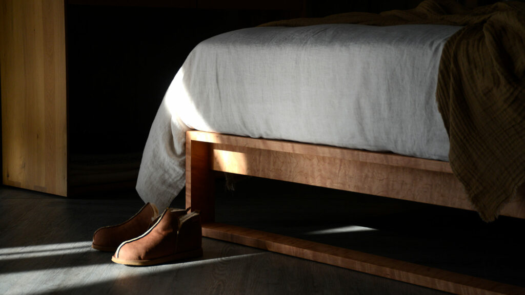 Modern Leith bed hand made in Britain from solid cherry wood a view of the foot end