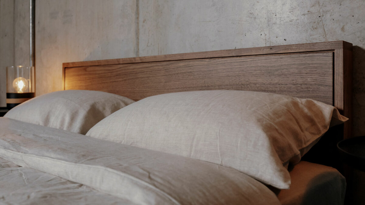 pale ecru linen bedding shown on our Leith walnut wood bed frame