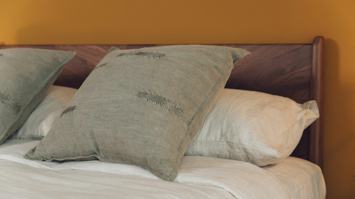 light olive cushions with embroidered details