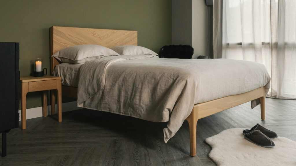 Highbury bed with a tall chevron pattern headboard here in oak