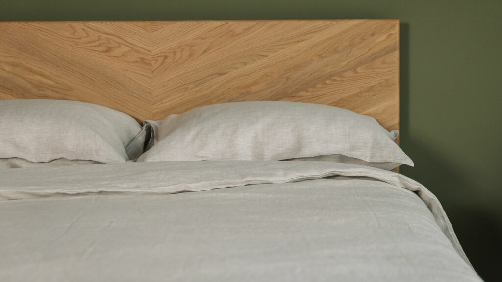 stone coloured linen bedding set including duvet cover, sheets and pillowcases shown on an Oak kingsize Highbury bed