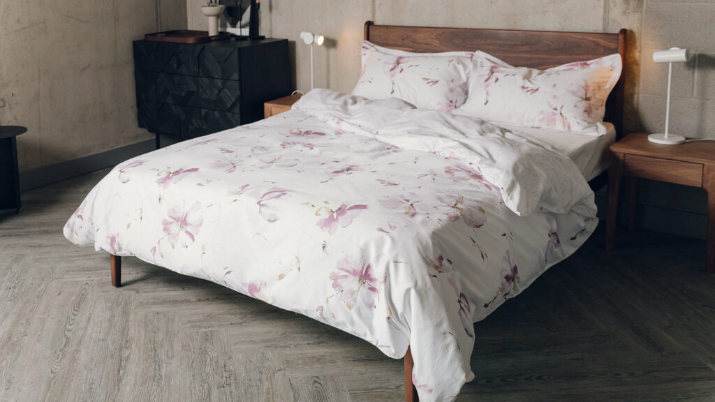 blossom print reversible duvet set in soft pink shown on a solid walnut wood Camden bed