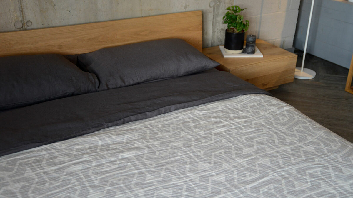 linen and cotton blend geometric throw in grey and ivory on oak oregon bed