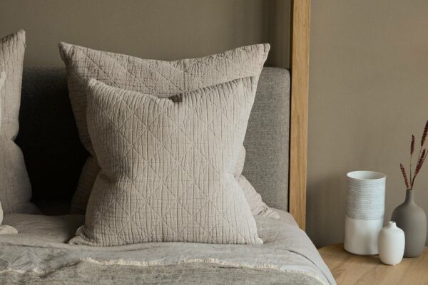 cotton and linen textured cushions on oak highland bed base, neutral bedding scheme