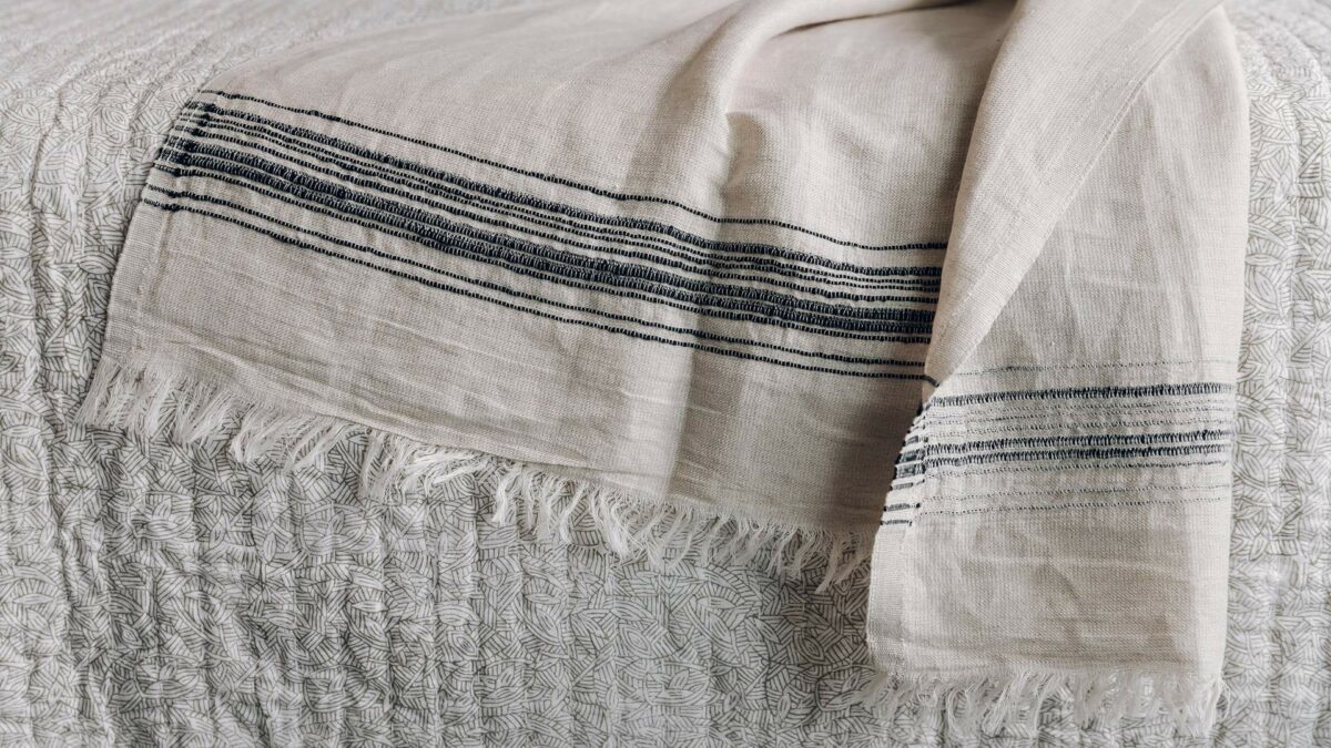 linen mix lightweight throw in sand with a woven black stripe