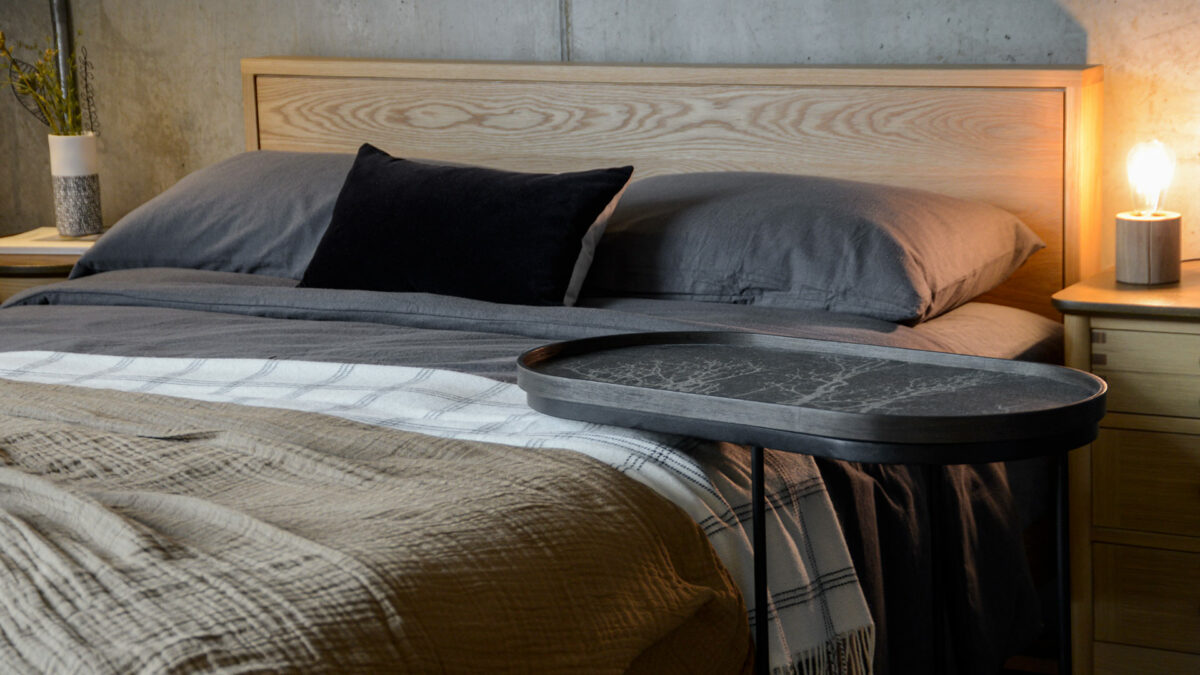 Ethnicraft lozenge shape side table shown over a bed and with optional tray