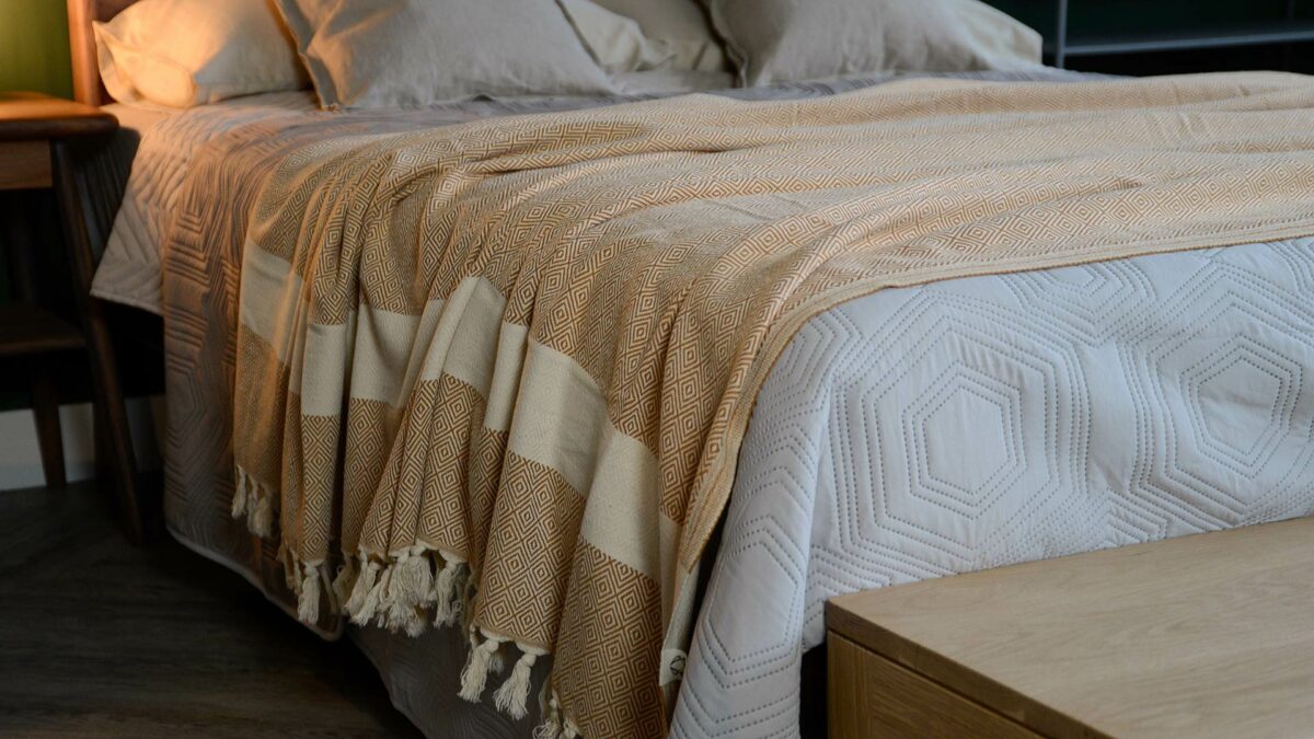luke linen diamond pattern throw orange on bed